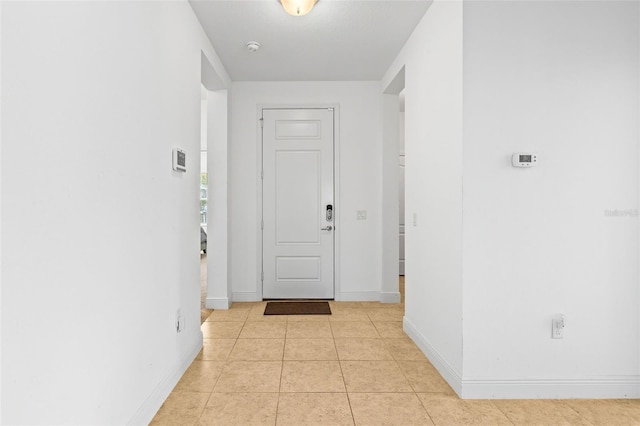 hall with light tile patterned floors