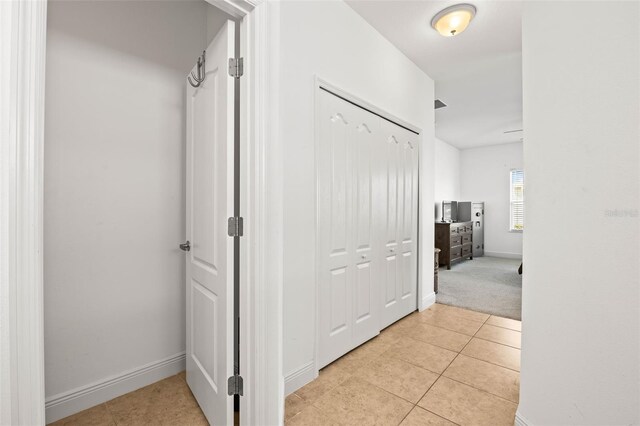 corridor featuring light tile patterned floors