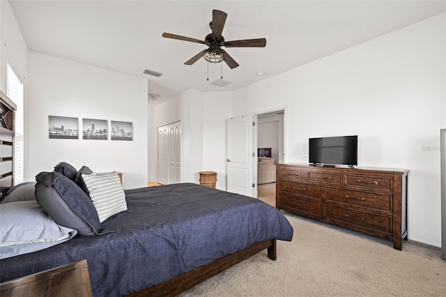 carpeted bedroom featuring ceiling fan and a closet