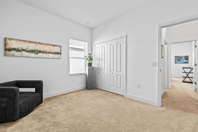 living area featuring light colored carpet