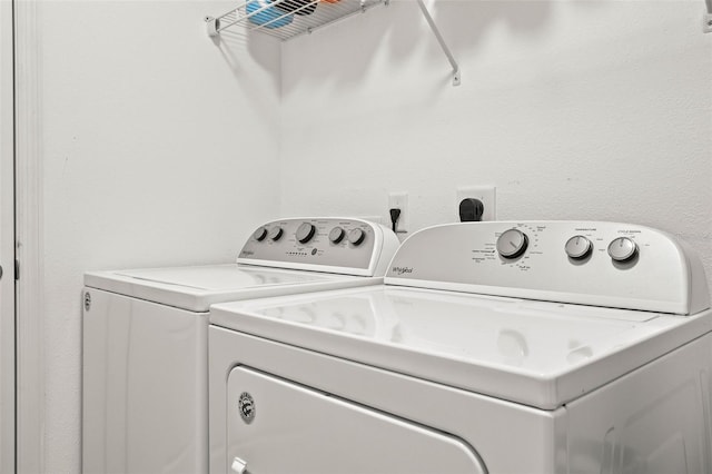 washroom with washing machine and clothes dryer