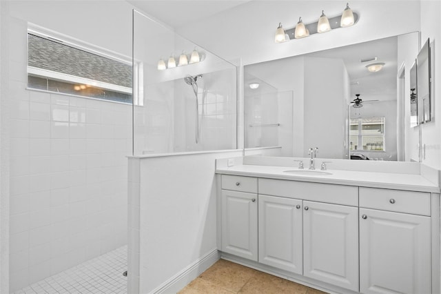 bathroom featuring ceiling fan, vanity, tile patterned flooring, and a tile shower