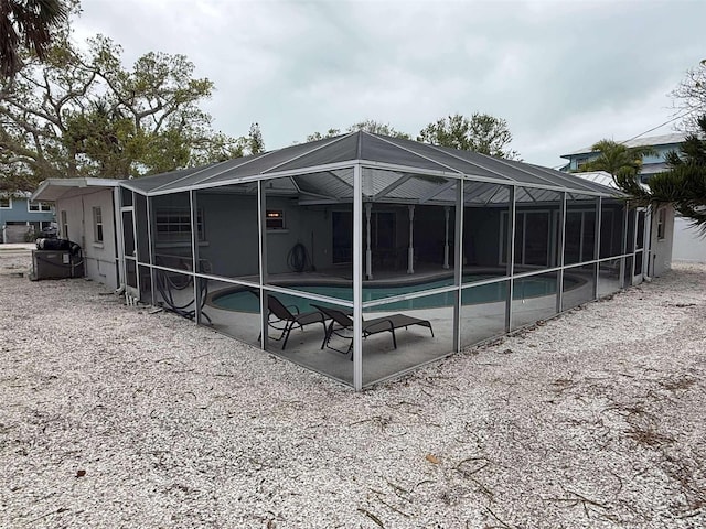 rear view of property with a lanai and a patio area