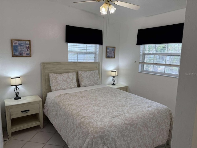 bedroom featuring light tile patterned floors and ceiling fan