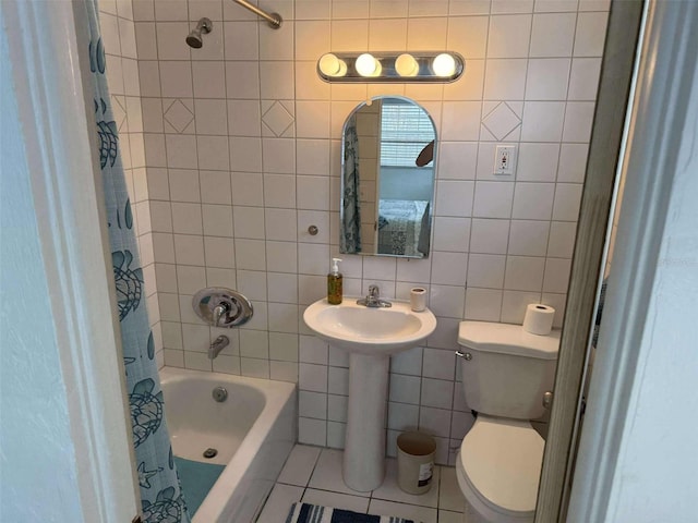 bathroom featuring tile patterned flooring, tile walls, shower / bath combination with curtain, and toilet