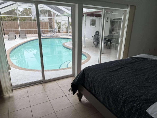 tiled bedroom featuring multiple windows and access to exterior