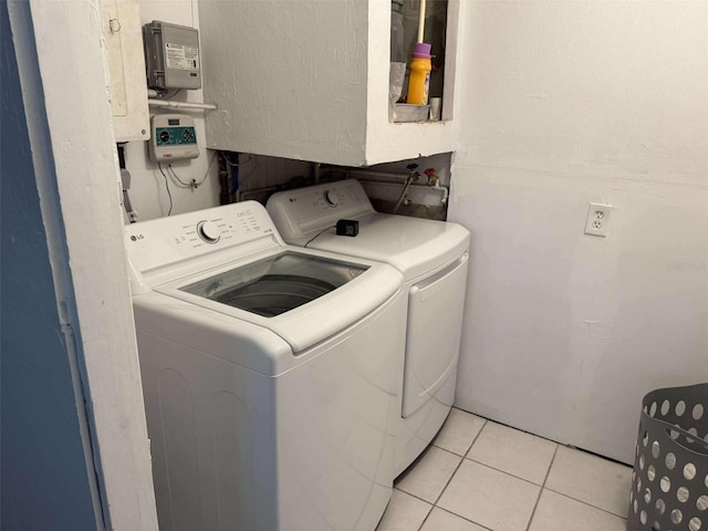 laundry room featuring independent washer and dryer and light tile patterned flooring