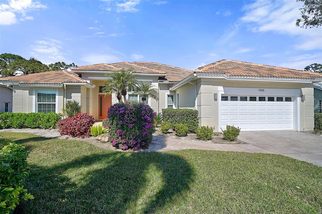 mediterranean / spanish house featuring a garage and a front lawn