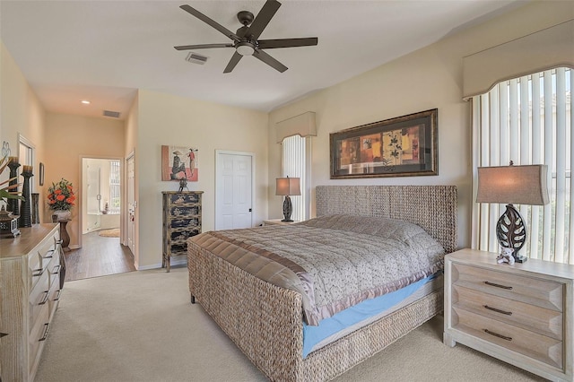 carpeted bedroom featuring ensuite bath and ceiling fan