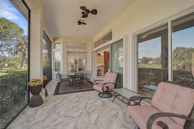 sunroom with ceiling fan