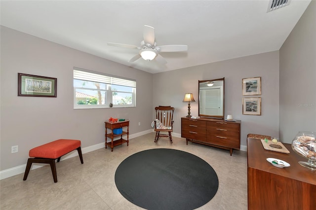 sitting room featuring light tile patterned floors and ceiling fan