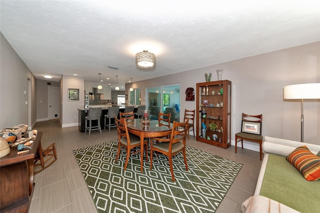 dining space with a textured ceiling