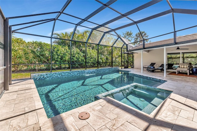 view of swimming pool featuring an in ground hot tub, a lanai, and a patio area