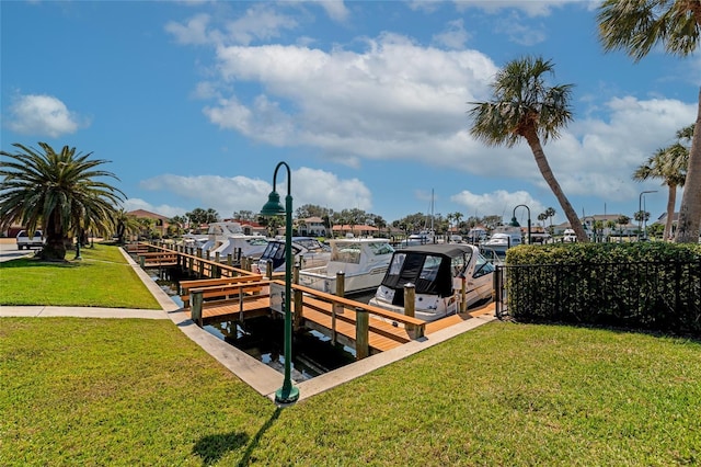 view of dock featuring a lawn