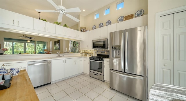 kitchen featuring sink, a wealth of natural light, white cabinets, and appliances with stainless steel finishes