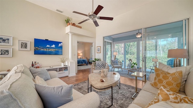 living room with hardwood / wood-style flooring and a high ceiling