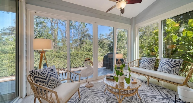 sunroom with ceiling fan, lofted ceiling, and plenty of natural light