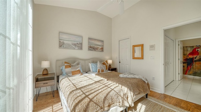 bedroom featuring vaulted ceiling and light wood-type flooring