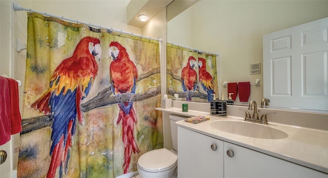 bathroom with vanity, walk in shower, and toilet