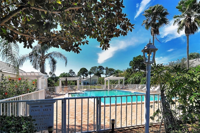 view of swimming pool featuring a pergola and a patio