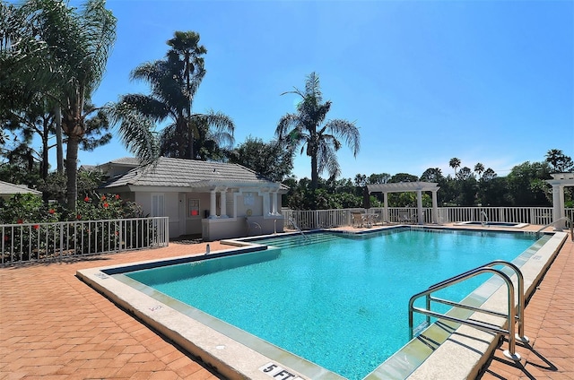 view of swimming pool with a patio and a pergola