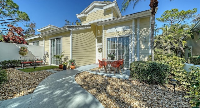 view of front facade with a patio area and fence