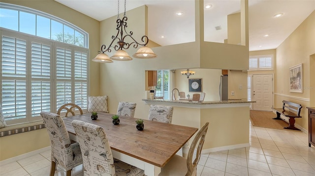 tiled dining space with a wealth of natural light and a high ceiling