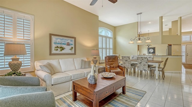 living room featuring vaulted ceiling, ceiling fan, and light tile patterned flooring