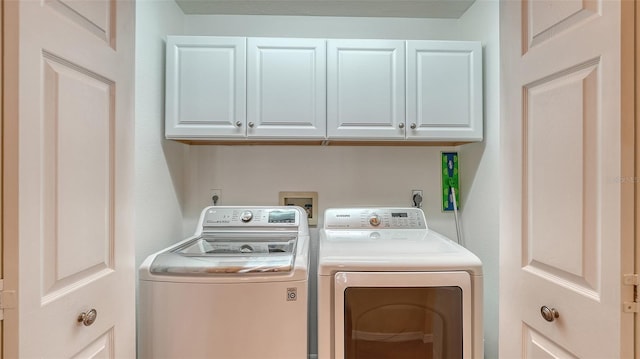 laundry area with cabinets and washing machine and clothes dryer