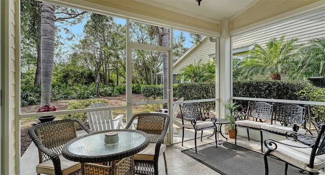 sunroom featuring vaulted ceiling