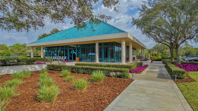 rear view of house featuring a sunroom