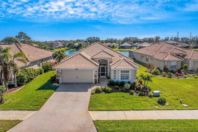 mediterranean / spanish-style home featuring a water view, a garage, and a front lawn