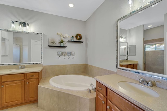 bathroom with shower with separate bathtub, vanity, and tile patterned floors