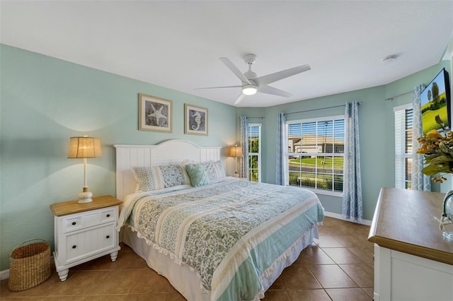 tiled bedroom featuring ceiling fan