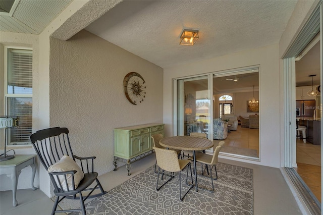 dining room with tile patterned flooring and a textured ceiling