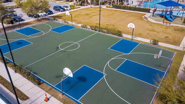 view of sport court with a playground and a yard