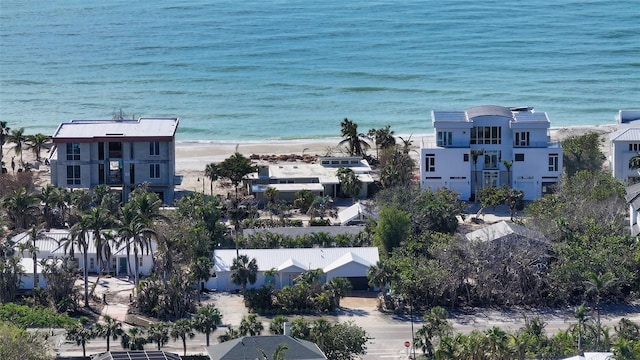 drone / aerial view featuring a water view and a beach view