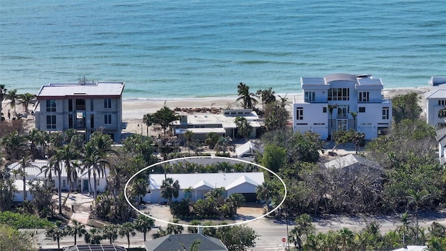 drone / aerial view with a water view and a view of the beach