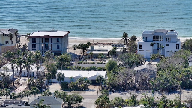 birds eye view of property featuring a beach view and a water view