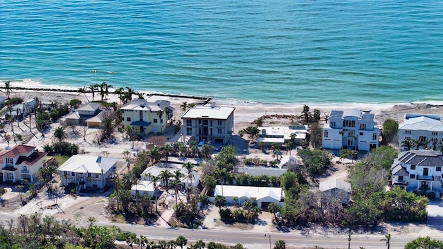 birds eye view of property featuring a beach view and a water view