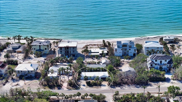 drone / aerial view featuring a water view and a view of the beach