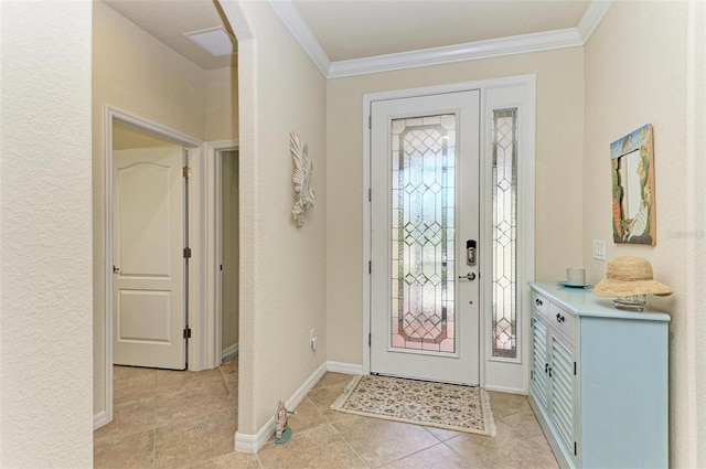 tiled entrance foyer featuring crown molding