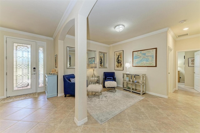 entrance foyer with ornamental molding and light tile patterned floors