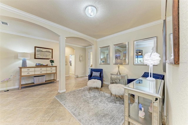 living area featuring ornamental molding, a textured ceiling, and light tile patterned floors