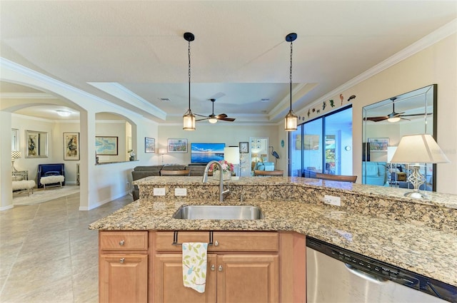 kitchen featuring crown molding, stainless steel dishwasher, a tray ceiling, and sink