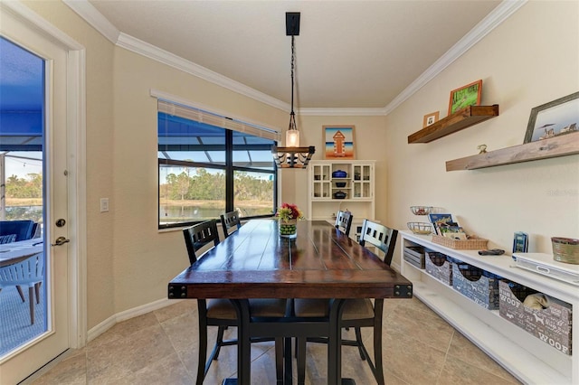 tiled dining room with ornamental molding and a chandelier