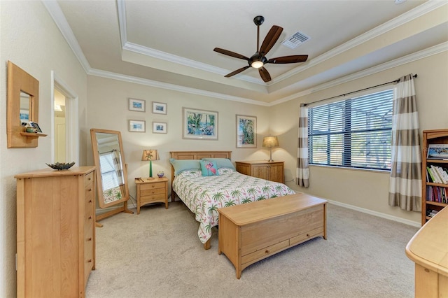 carpeted bedroom with crown molding, ceiling fan, and a tray ceiling