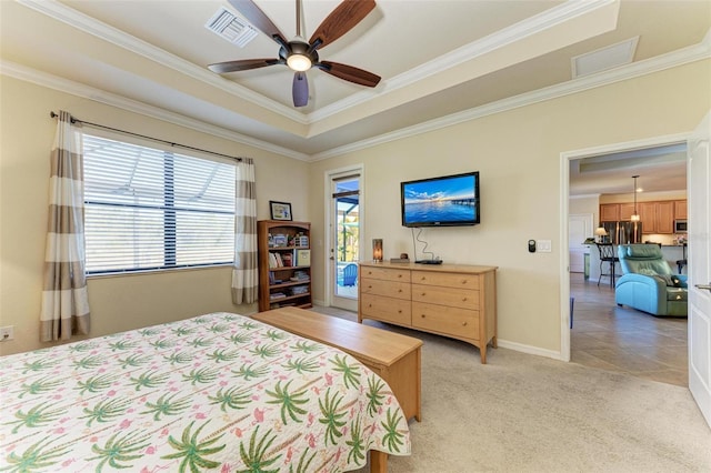 bedroom featuring a tray ceiling, crown molding, light colored carpet, and ceiling fan