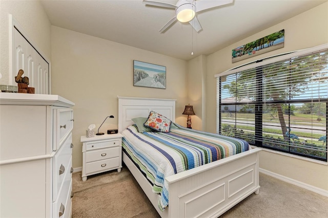 bedroom featuring ceiling fan and light colored carpet