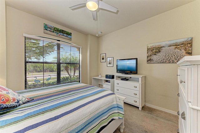 bedroom with light carpet and ceiling fan